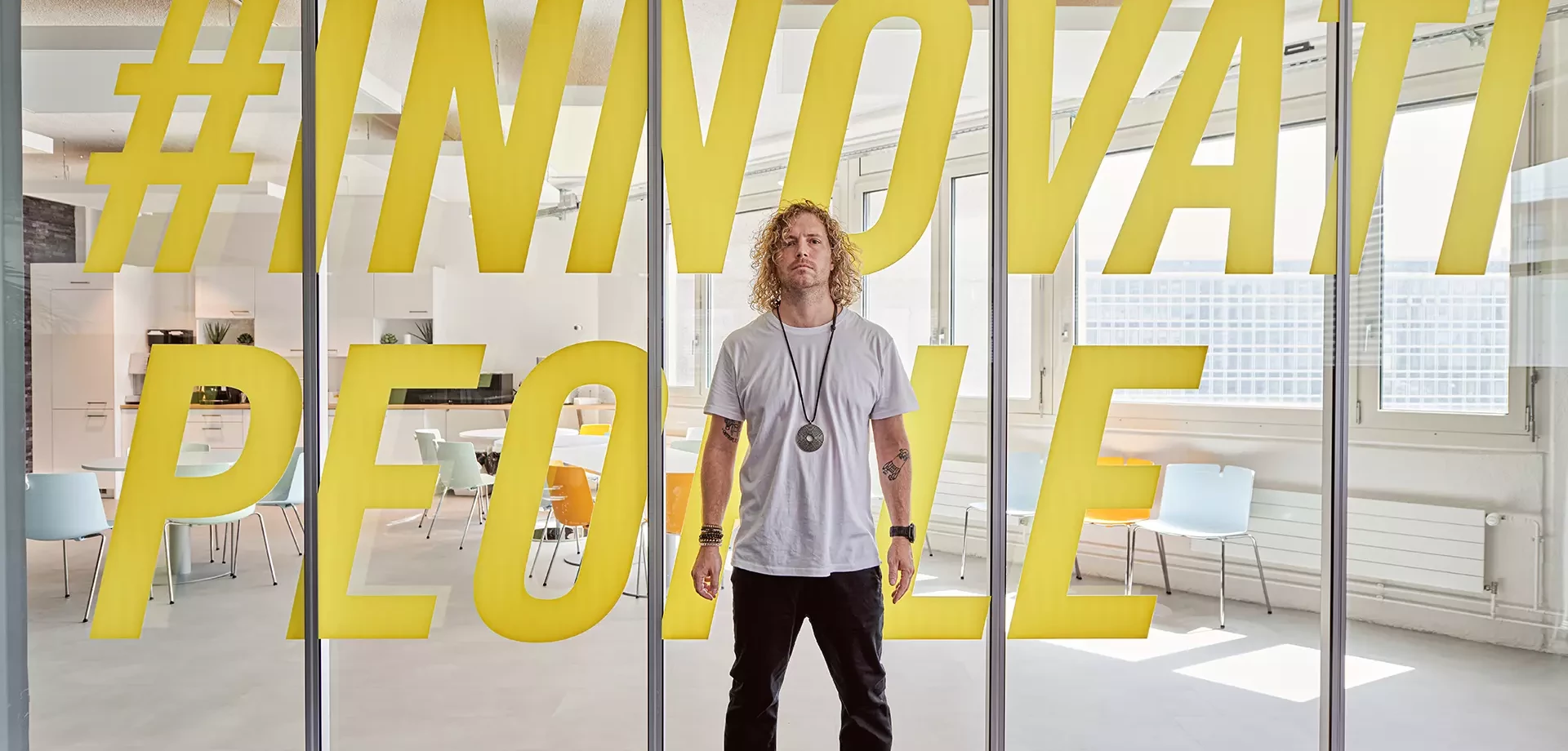 un homme devant une vitrine de bureau avec des lettres imprimées et collées