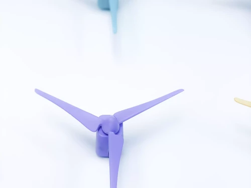 petites éoliennes de couleur contre un mur blanc