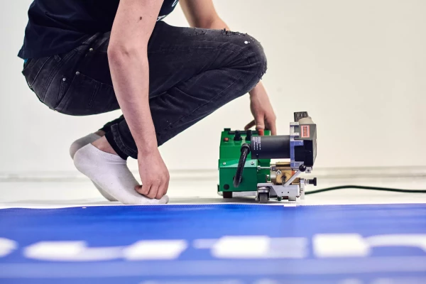 soudure d'un bâche publicitaire pour un chantier